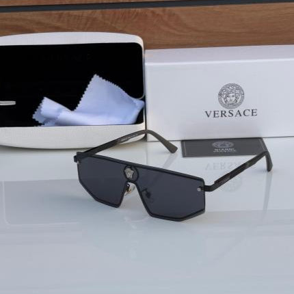 Versace sunglasses with packaging on a reflective surface
